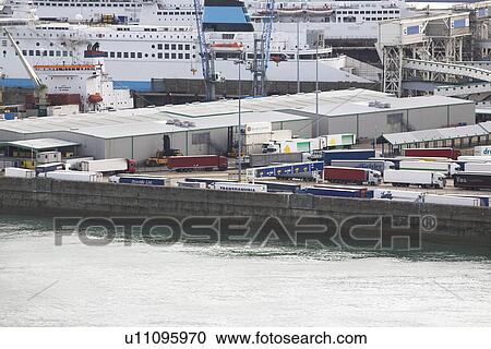 Stock Image - Harbor with trucks and ship. Fotosearch