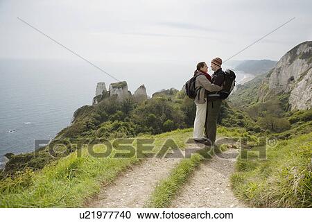 Stock Image - Hiking Couple Standing on a Path. Fotosearch