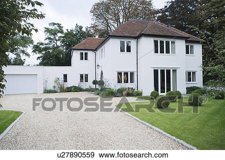 Stock Photo - House exterior with surrounding yard and driveway. Fotosearch