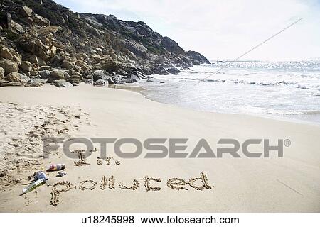 Stock Photo - I'm polluted text written on beach elevated view. Fotosearch