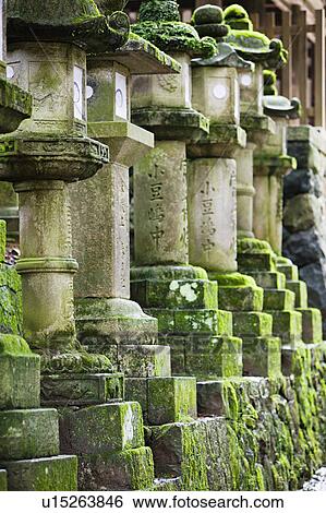 Stock Photograph - Japan Mara Row of stone lanterns in garden. Fotosearch