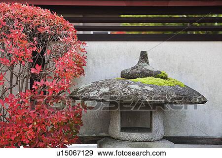 Stock Photo - Japan Takayama Stone Lantern and bush in Autumn colors. Fotosearch
