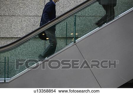 Japan Tokyo Tokyo International Forum two men ascending escalator mid section View Large Photo Image Picture - Japan Tokyo Tokyo International Forum two men ascending escalator mid section. Fotosearch