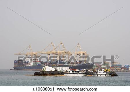 Khor Fakkan UAE Large cargo ships docked to load and unload goods at Khor Fakkport View Large Photo Image Stock Image - Khor Fakkan UAE Large cargo ships docked to load and unload goods at Khor Fakkport. Fotosearch