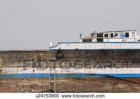 Khor Fakkan UAE old wooden dhow washed up on shore in front of Khor Fakkport View Large Photo Image Stock Image - Khor Fakkan UAE old wooden dhow washed up on shore in front of Khor Fakkport. Fotosearch