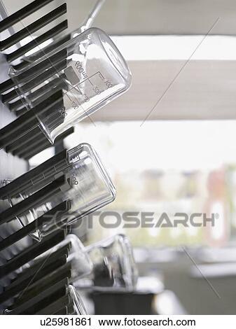Stock Image - Laboratory flasks on drying rack. Fotosearch