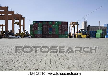Stock Image - Limassol Cyprus Mobile crane moving containers in stockyard. Fotosearch