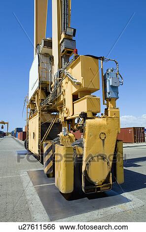 Stock Photograph - Limassol Cyprus Mobile crane moving containers in stockyard. Fotosearch