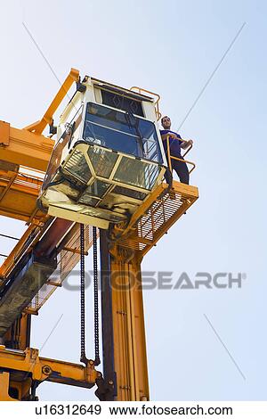 Limassol Cyprus Operator having a break on gantry of mobile crane View Large Photo Image Stock Photo - Limassol Cyprus Operator having a break on gantry of mobile crane. Fotosearch