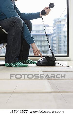 Man dialing phone at home low section side view View Large Photo Image Stock Photo - Man dialing phone at home low section side view. Fotosearch