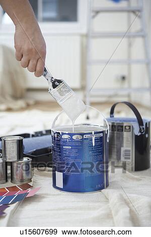 Man dipping paint brush into can close up of hand View Large Photo Image Stock Photo - Man dipping paint brush into can close up of hand. Fotosearch