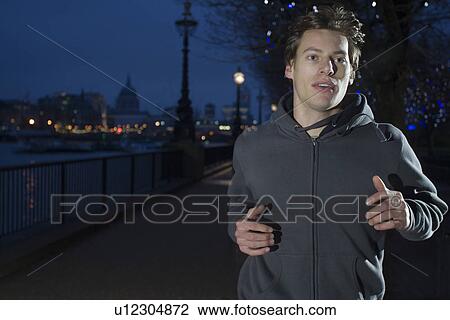 Man jogging at night View Large Photo Image Stock Image - Man jogging at night. Fotosearch