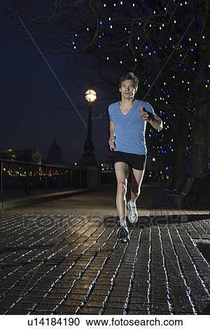 Man jogging at night View Large Photo Image Stock Image - Man jogging at night. Fotosearch
