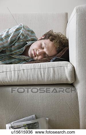 Stock Photograph - Man napping on sofa. Fotosearch
