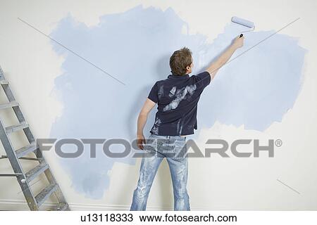 Man painting wall back view View Large Photo Image Stock Image - Man painting wall back view. Fotosearch