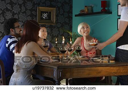 Man serving birthday cake to people sitting at dining table View Large Photo Image Stock Image - Man serving birthday cake to people sitting at dining table. Fotosearch