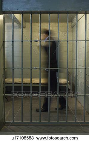 Man walking in prison cell View Large Photo Image Stock Photo - Man walking in prison cell. Fotosearch