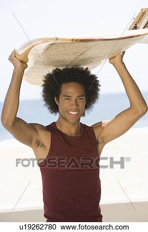 Stock Image - Man with surfboard. Fotosearch