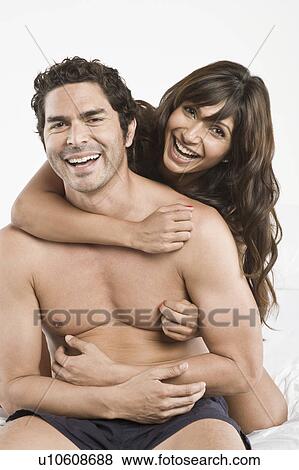 Mid adult couple being playful in bed View Large Photo Image Stock Photo - Mid adult couple being playful in bed. Fotosearch