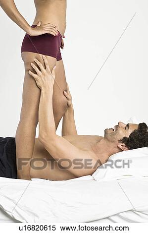 Stock Photography - Mid adult couple in bedroom. Fotosearch