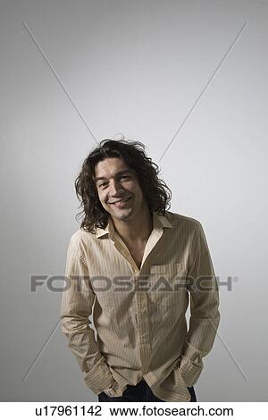 Mid-adult man smiling studio shot View Large Photo Image Stock Image - Mid-adult man smiling studio shot. Fotosearch
