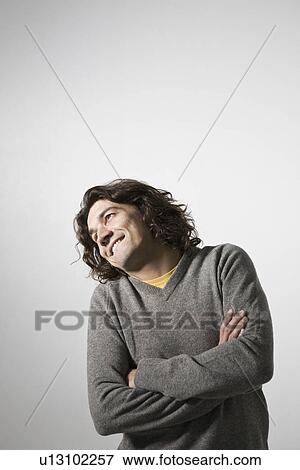 Stock Photo - Mid-adult man smiling studio shot. Fotosearch