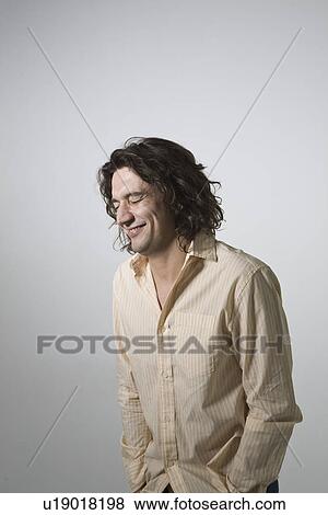 Mid-adult man smiling studio shot View Large Photo Image Stock Photo - Mid-adult man smiling studio shot. Fotosearch