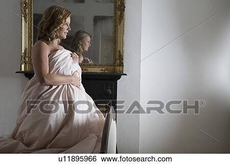 Mid adult woman getting up from bed View Large Photo Image Stock Photograph - Mid adult woman getting up from bed. Fotosearch