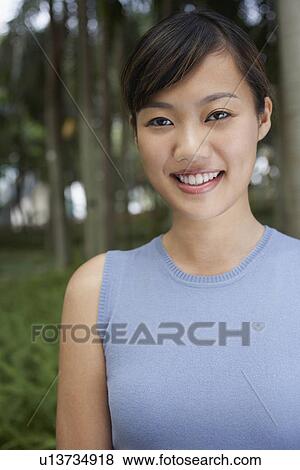 Mid adult woman in park portrait View Large Photo Image Stock Photo - Mid adult woman in park portrait. Fotosearch
