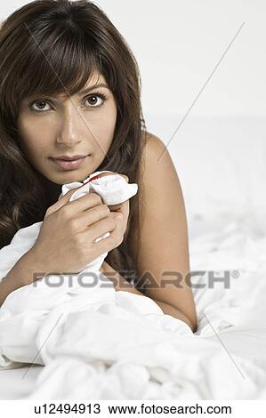 Mid adult woman lying in bed View Large Photo Image Stock Image - Mid adult woman lying in bed. Fotosearch