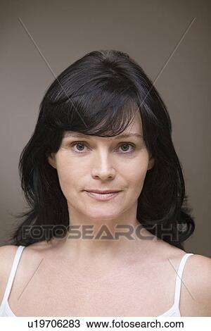 Stock Image - Mid adult woman wearing bra. Fotosearch