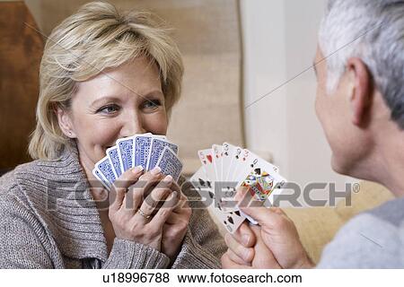 Middle-aged couple playing cards View Large Photo Image Stock Photo - Middle-aged couple playing cards. Fotosearch