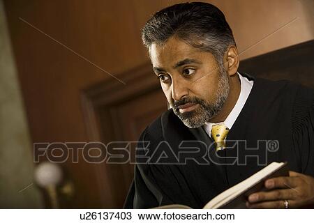 Stock Image - Middle-aged judge in a courtroom. Fotosearch