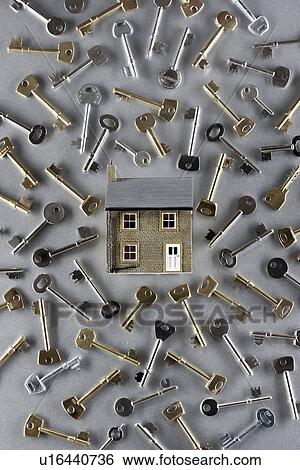 Stock Photograph - Model house and large group of keys. Fotosearch