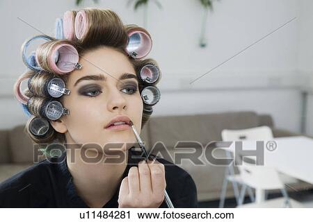 Model in Hair Curlers Applying Lip Gloss View Large Photo Image Stock Image - Model in Hair Curlers Applying Lip Gloss. Fotosearch