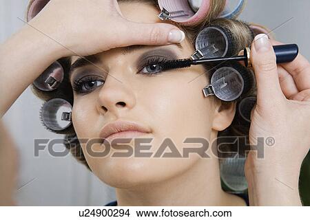 Picture - Model in Hair Curlers Having Makeup Applied. Fotosearch