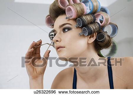 Model in Hair Curlers Using Eyelash Curler View Large Photo Image Stock Photograph - Model in Hair Curlers Using Eyelash Curler. Fotosearch