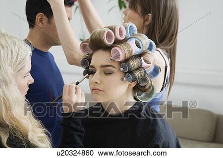 Stock Image - Models Being Prepared for Photo Shoot. Fotosearch