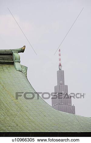 Stock Photography - Modern Skyscraper Behind Traditional Roof of Meiji Shrine. Fotosearch