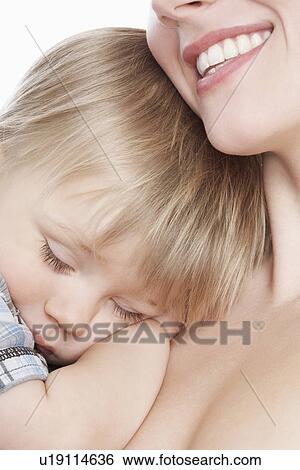 Mother cuddling sleeping son (1-2) close-up View Large Photo Image Stock Photograph - Mother cuddling sleeping son (1-2) close-up. Fotosearch