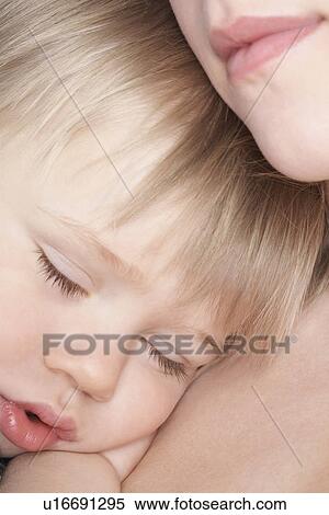 Mother cuddling sleeping son (1-2) close-up View Large Photo Image Stock Photography - Mother cuddling sleeping son (1-2) close-up. Fotosearch