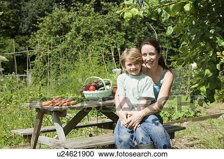 Mother sitting with son in garden portrait View Large Photo Image Stock Image - Mother sitting with son in garden portrait. Fotosearch