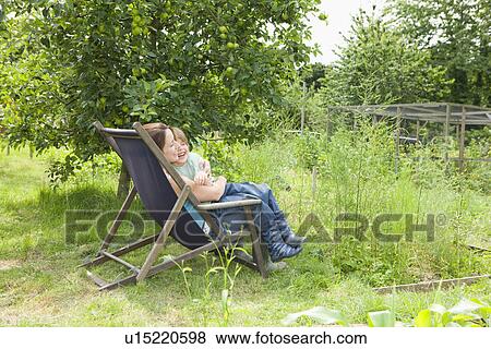 Stock Photo - Mother sitting with son in garden. Fotosearch