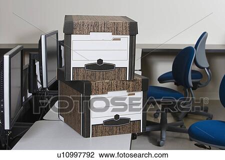 Stock Image - Moving Boxes on Office Desk. Fotosearch