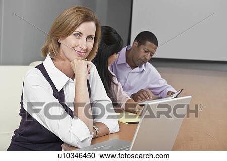 Stock Image - Multi Racial Group of Business People Working. Fotosearch