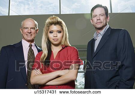Stock Image - Multi Racial Group of Serious Business People Low Angle. Fotosearch