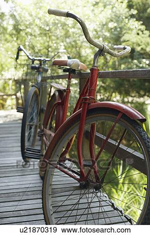 Stock Photo - Old bicycles on porch. Fotosearch