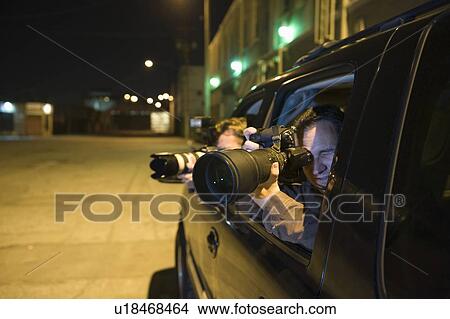 Picture - Paparazzi photographer in car. Fotosearch