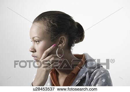 Stock Photo - Pensive young woman close-up view. Fotosearch