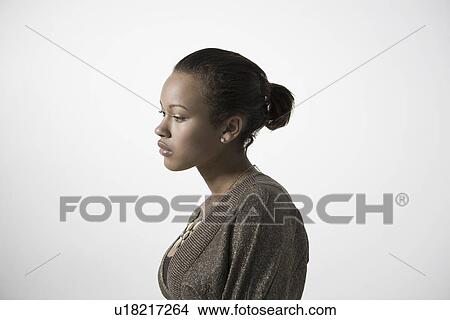Picture - Pensive young woman profile close-up view. Fotosearch